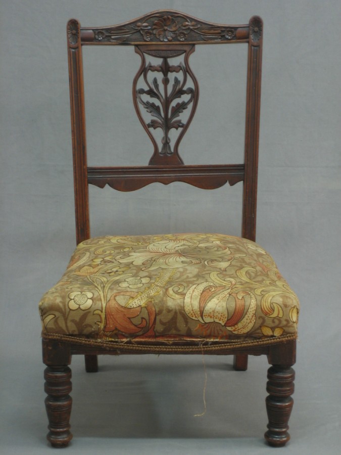 Lot No 149 A Victorian carved walnut nursing chair with vase shaped