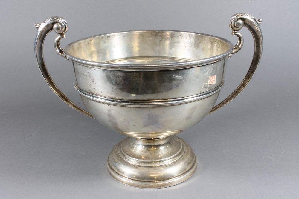 A silver twin handled pedestal bowl raised on a 10th July 2013 Denhams