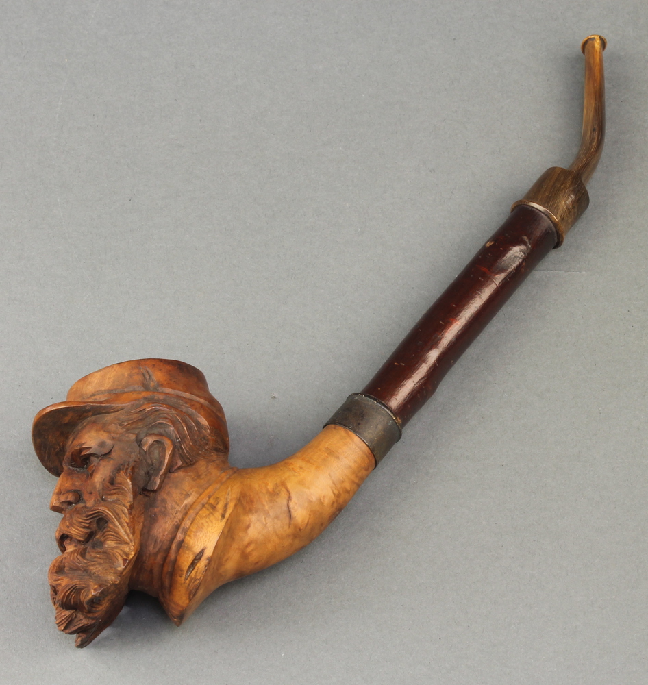 A 19th Century carved wooden pipe, the bowl in the 28th September