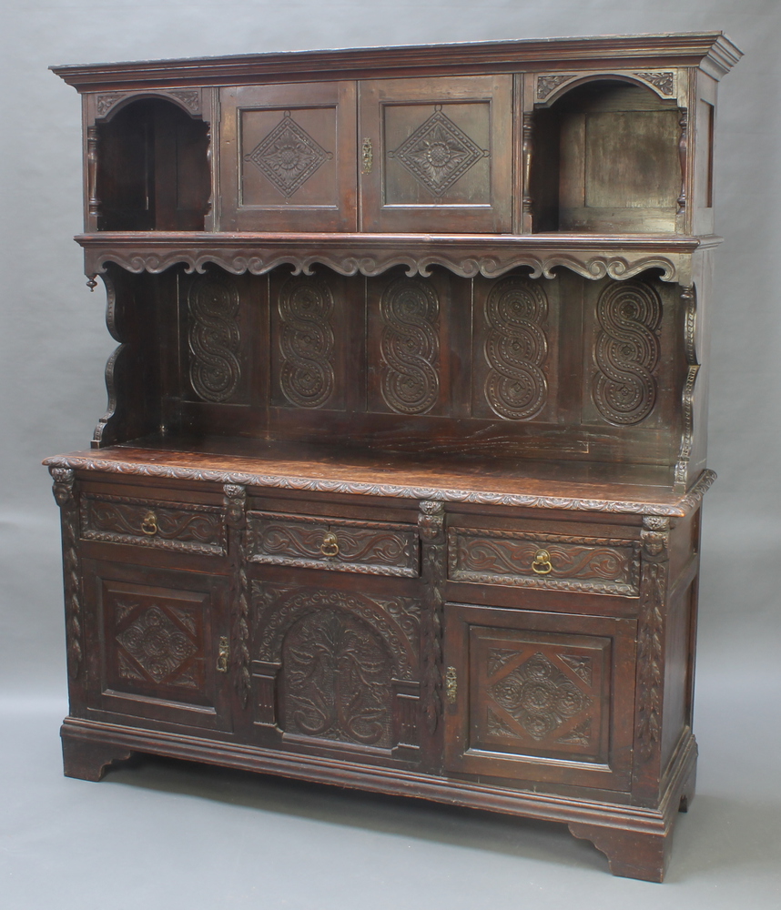 A Victorian heavily carved dark oak dresser, the upper 19th April