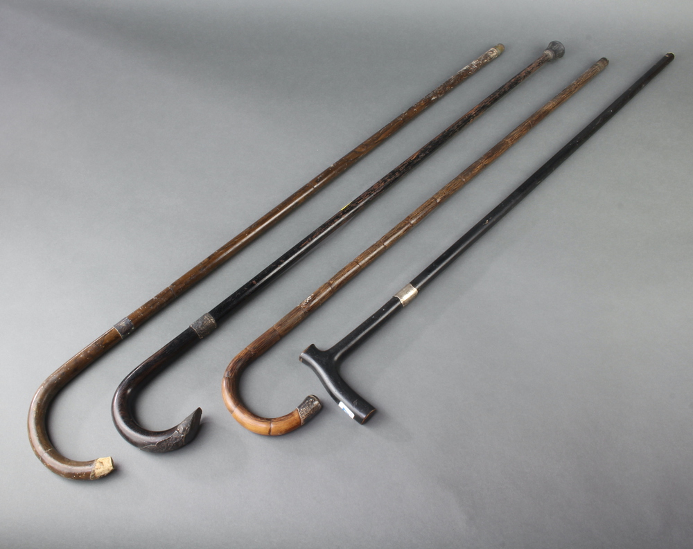 An ebonised walking cane with silver collar 3 others 4th November