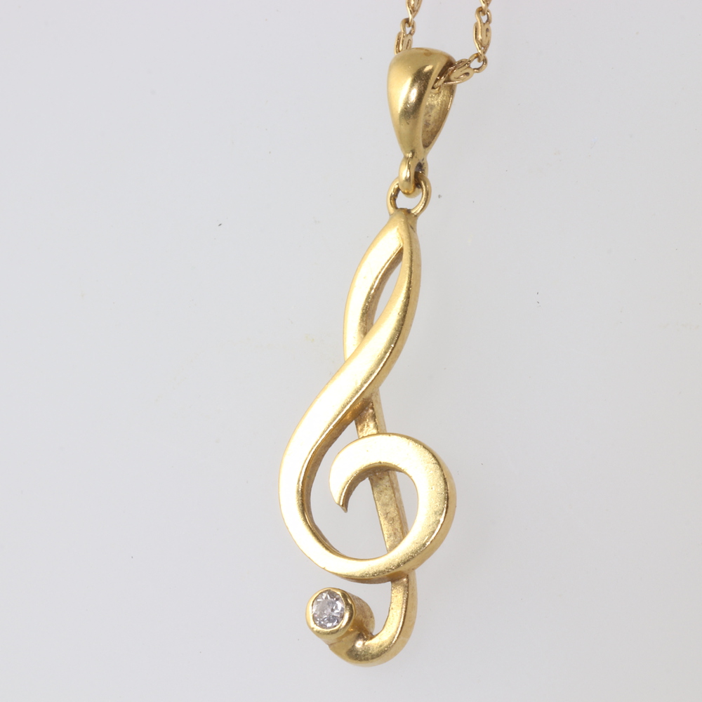 An 18ct yellow gold diamond set musical note pendant 27th July 2022 Denhams