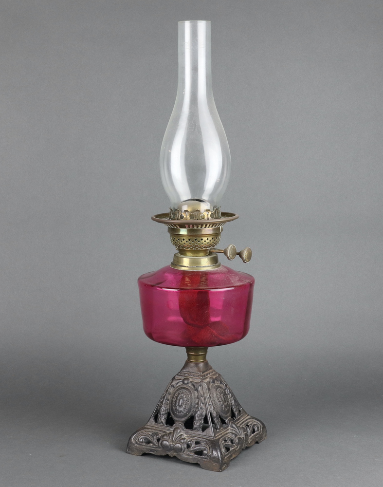 A Victorian cranberry glass oil lamp reservoir raised 16th November