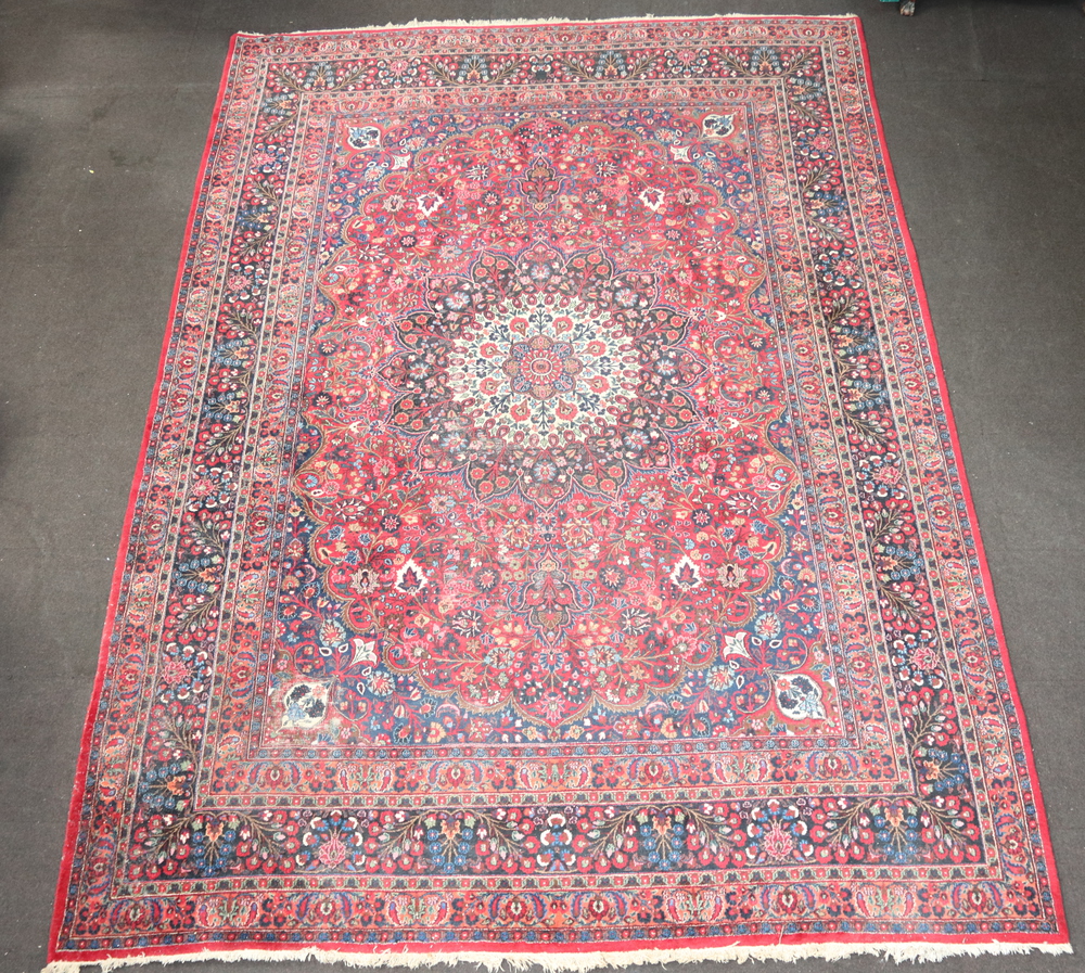 A blue and red ground North West Persian carpet with 16th November