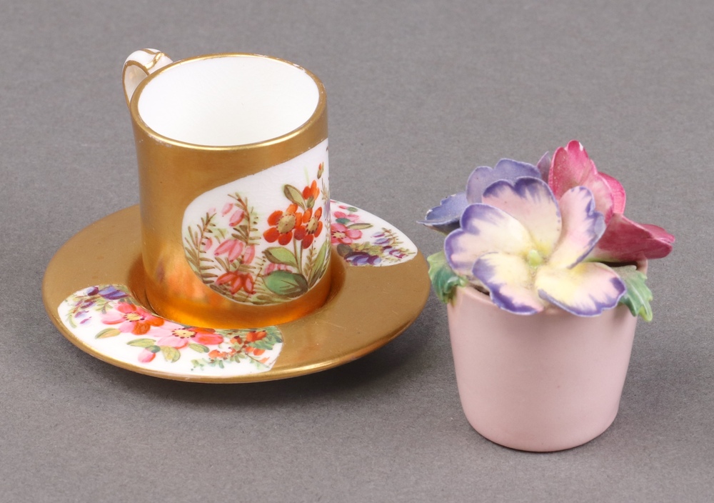 A Coalport porcelain miniature cup and saucer with | 23rd April